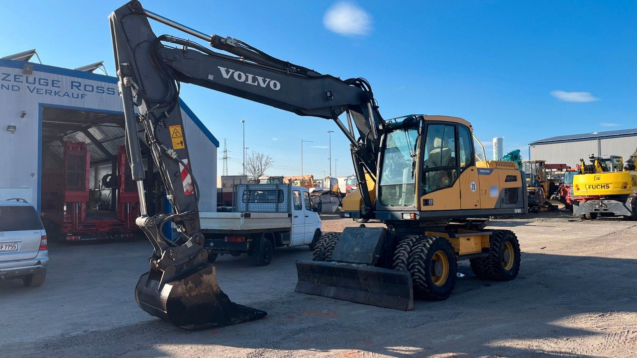 Volvo EW180D 20500 Kg Verstellausleger OilQuick - Bager na kotačima: slika Volvo EW180D 20500 Kg Verstellausleger OilQuick - Bager na kotačima Volvo EW180D 20500 Kg Verstellausleger OilQuick - Bager na kotačima: slika Volvo EW180D 20500 Kg Verstellausleger OilQuick - Bager na kotačima