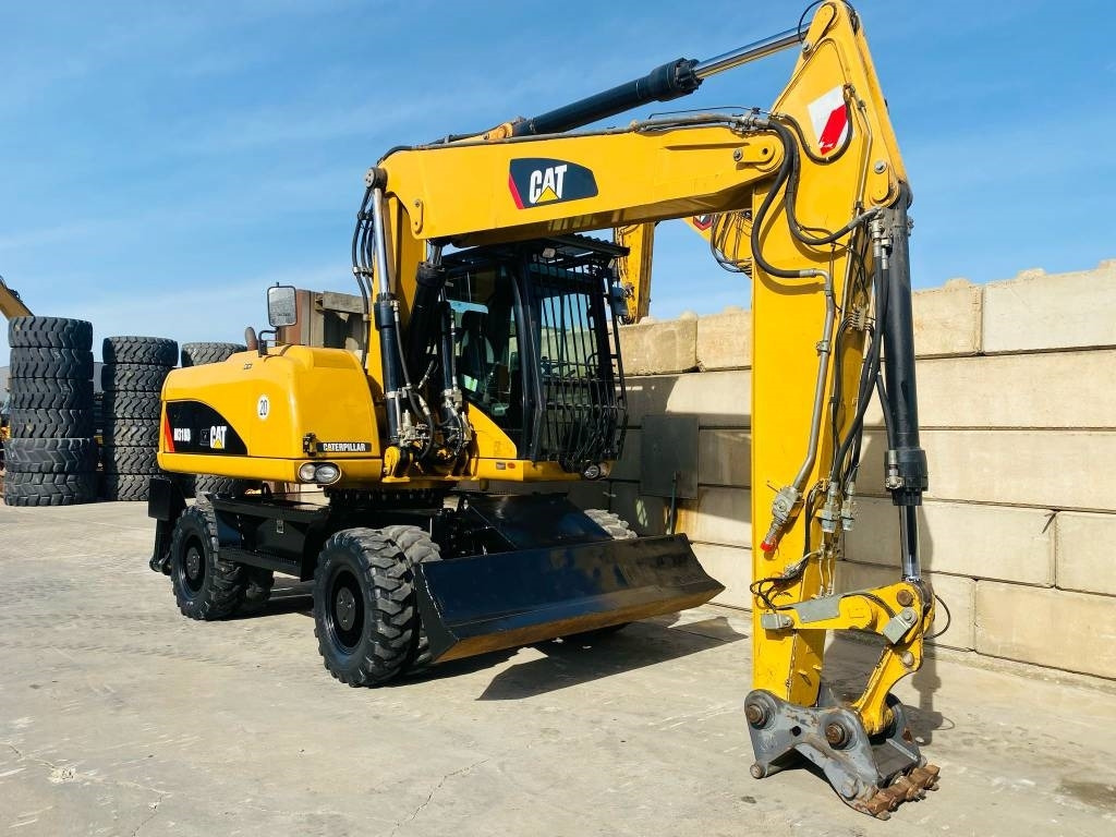 CAT M 318 D - Bager na kotačima: slika CAT M 318 D - Bager na kotačima CAT M 318 D - Bager na kotačima: slika CAT M 318 D - Bager na kotačima