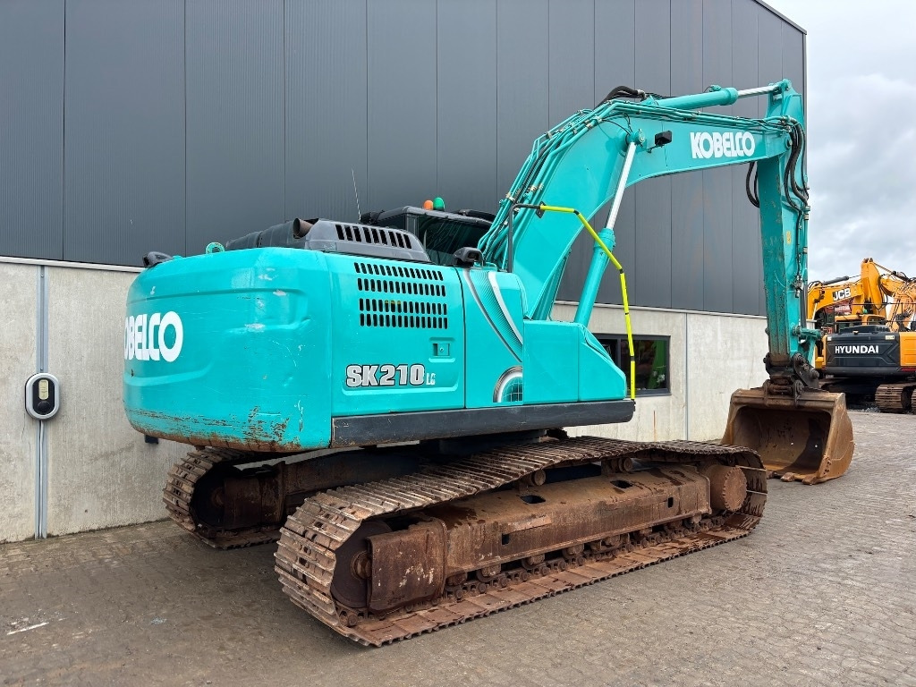 Kobelco SK 210 LC-10 - Bager gusjeničar: slika Kobelco SK 210 LC-10 - Bager gusjeničar Kobelco SK 210 LC-10 - Bager gusjeničar: slika Kobelco SK 210 LC-10 - Bager gusjeničar