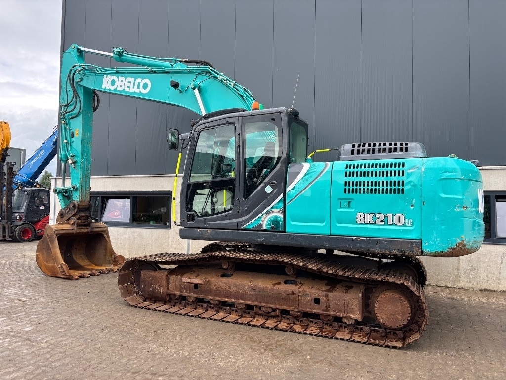 Kobelco SK 210 LC-10 - Bager gusjeničar: slika Kobelco SK 210 LC-10 - Bager gusjeničar Kobelco SK 210 LC-10 - Bager gusjeničar: slika Kobelco SK 210 LC-10 - Bager gusjeničar