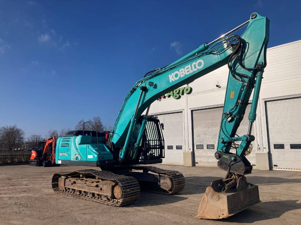 Kobelco SK 210 LC-10 - Bager gusjeničar: slika Kobelco SK 210 LC-10 - Bager gusjeničar Kobelco SK 210 LC-10 - Bager gusjeničar: slika Kobelco SK 210 LC-10 - Bager gusjeničar