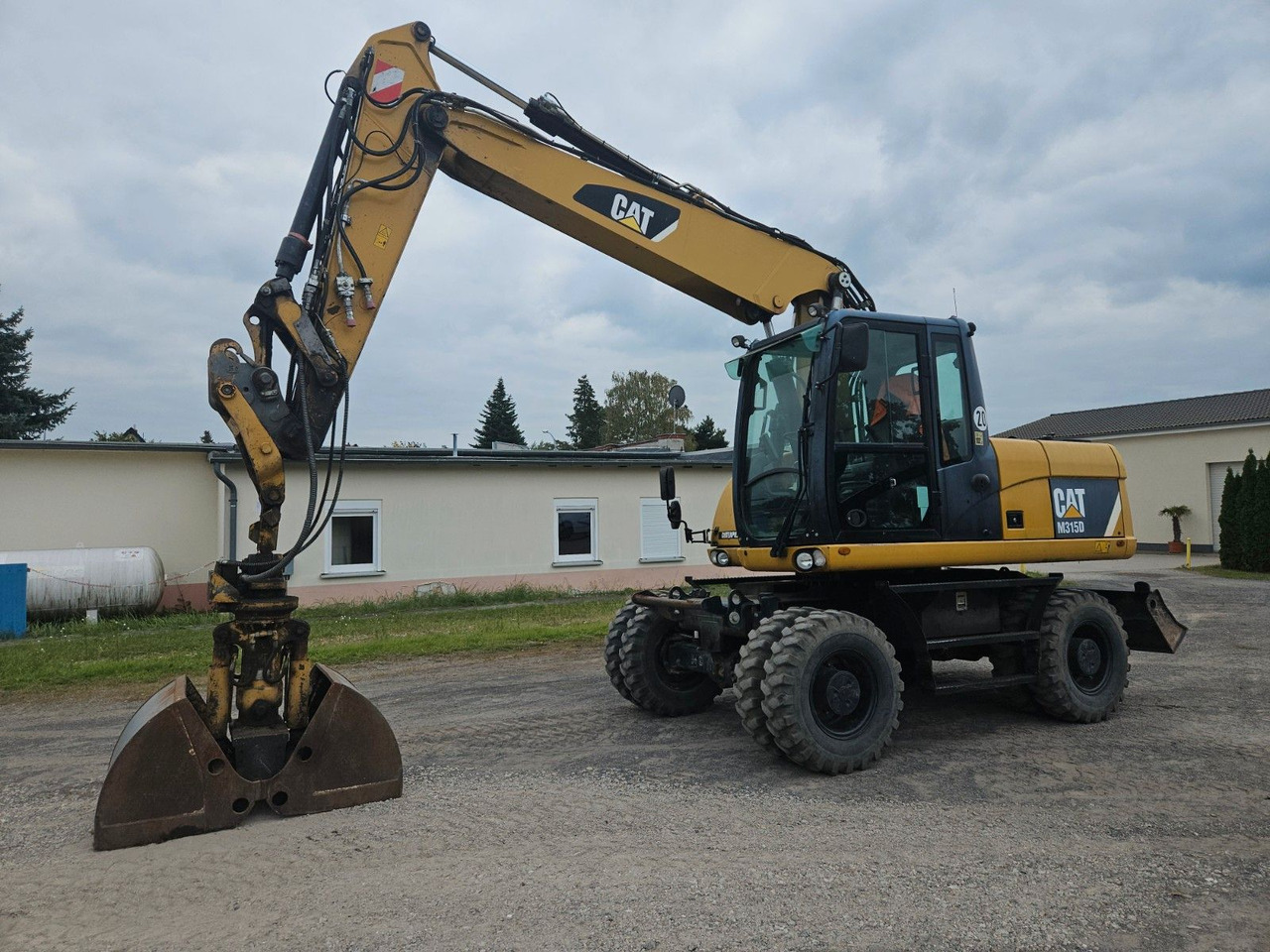 CAT M315D orig. 4.129h - Bager na kotačima: slika CAT M315D orig. 4.129h - Bager na kotačima CAT M315D orig. 4.129h - Bager na kotačima: slika CAT M315D orig. 4.129h - Bager na kotačima