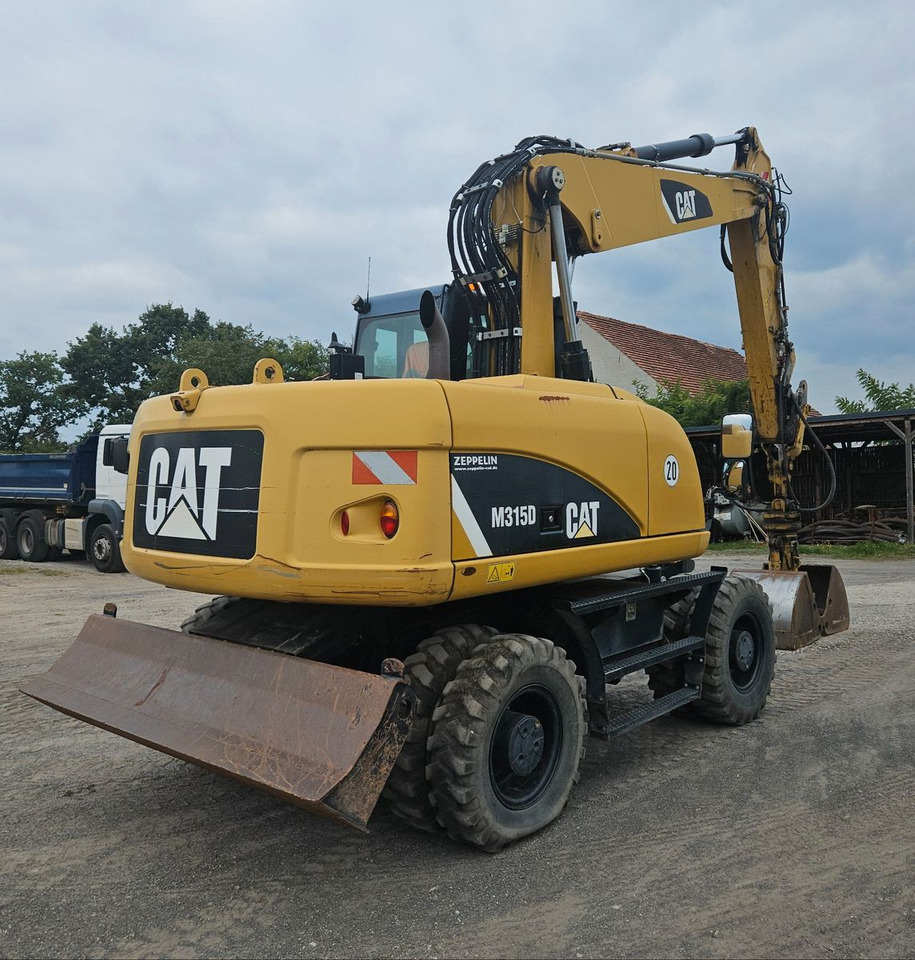 CAT M315D orig. 4.129h - Bager na kotačima: slika CAT M315D orig. 4.129h - Bager na kotačima CAT M315D orig. 4.129h - Bager na kotačima: slika CAT M315D orig. 4.129h - Bager na kotačima