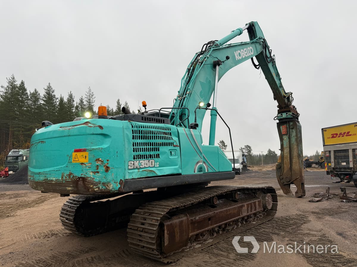 Grävmaskin Kobelco SK350LC-10 med stålsax - Bager gusjeničar: slika Grävmaskin Kobelco SK350LC-10 med stålsax - Bager gusjeničar Grävmaskin Kobelco SK350LC-10 med stålsax - Bager gusjeničar: slika Grävmaskin Kobelco SK350LC-10 med stålsax - Bager gusjeničar
