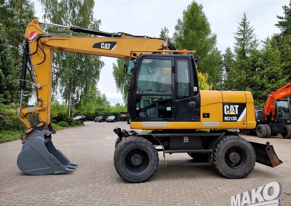 Caterpillar M313D - Bager na kotačima: slika Caterpillar M313D - Bager na kotačima Caterpillar M313D - Bager na kotačima: slika Caterpillar M313D - Bager na kotačima