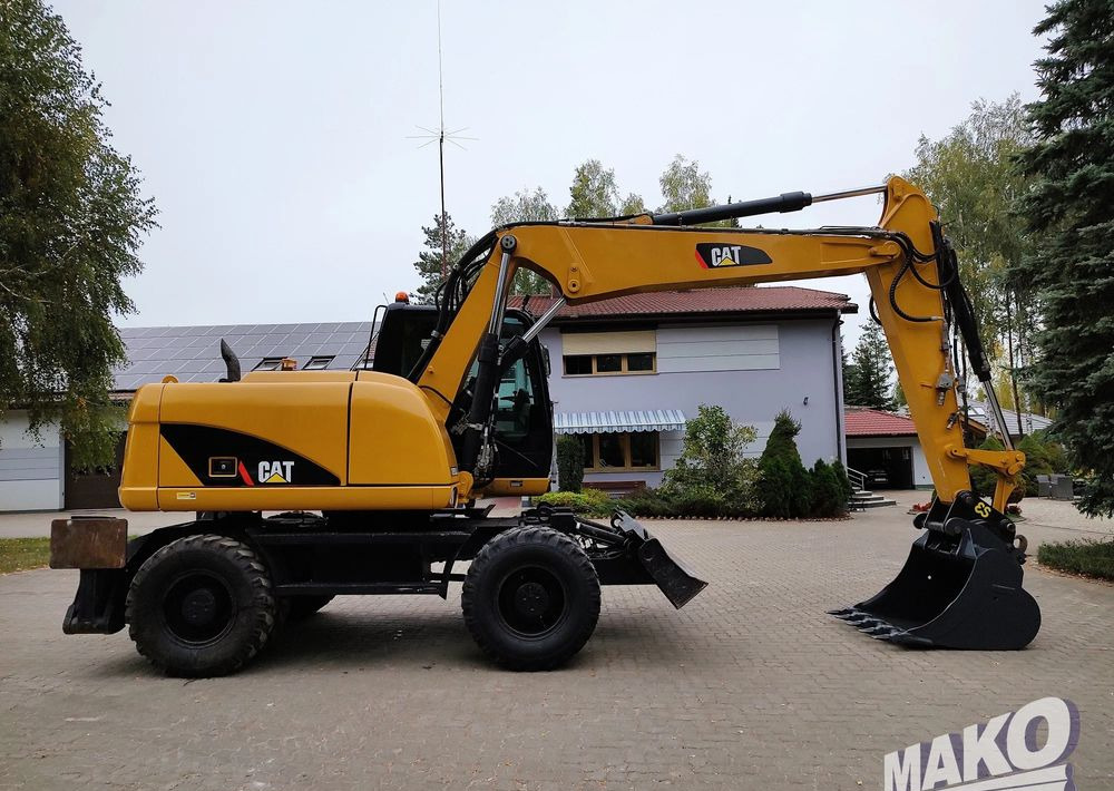 Caterpillar M313D - Bager na kotačima: slika Caterpillar M313D - Bager na kotačima Caterpillar M313D - Bager na kotačima: slika Caterpillar M313D - Bager na kotačima