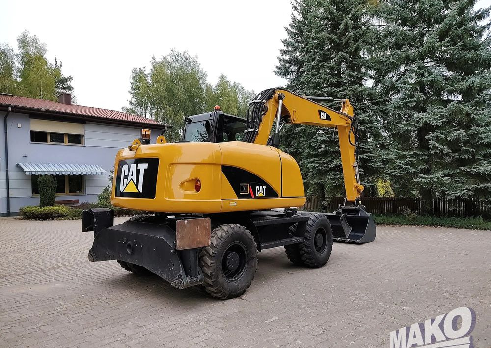 Caterpillar M313D - Bager na kotačima: slika Caterpillar M313D - Bager na kotačima Caterpillar M313D - Bager na kotačima: slika Caterpillar M313D - Bager na kotačima