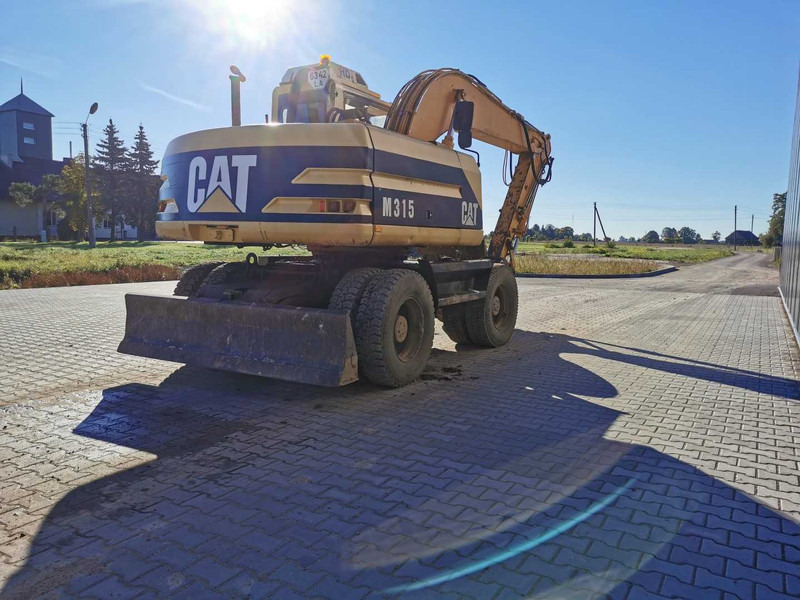 Caterpillar M315 wheel excavator - Bager na kotačima: slika Caterpillar M315 wheel excavator - Bager na kotačima Caterpillar M315 wheel excavator - Bager na kotačima: slika Caterpillar M315 wheel excavator - Bager na kotačima