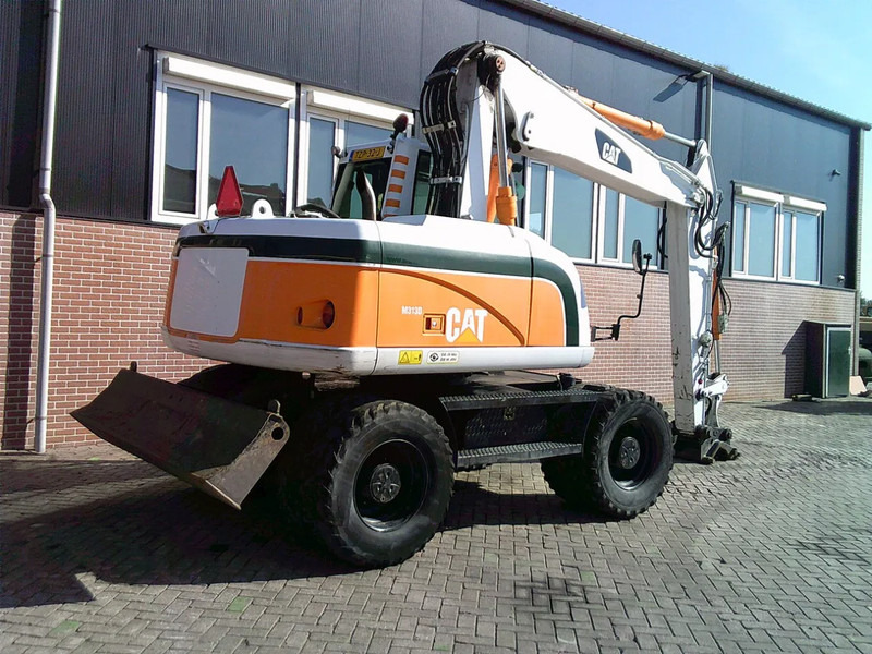 Caterpillar M313D - Bager na kotačima: slika Caterpillar M313D - Bager na kotačima Caterpillar M313D - Bager na kotačima: slika Caterpillar M313D - Bager na kotačima