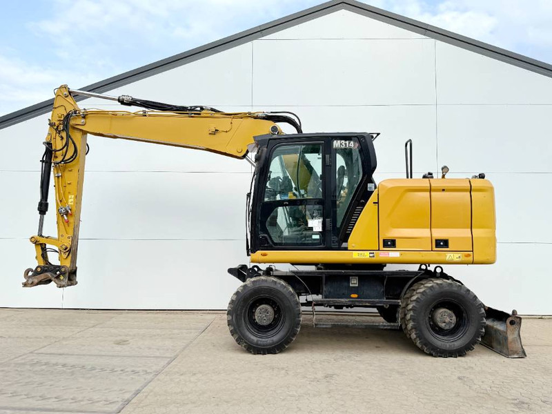 Cat M314 07A - Triple Boom / Automatic Greasing - Bager na kotačima: slika Cat M314 07A - Triple Boom / Automatic Greasing - Bager na kotačima Cat M314 07A - Triple Boom / Automatic Greasing - Bager na kotačima: slika Cat M314 07A - Triple Boom / Automatic Greasing - Bager na kotačima