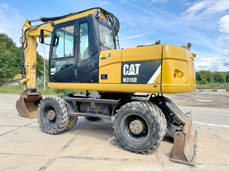 Cat M315D - Triple Boom / Quick Coupler - Bager na kotačima: slika Cat M315D - Triple Boom / Quick Coupler - Bager na kotačima Cat M315D - Triple Boom / Quick Coupler - Bager na kotačima: slika Cat M315D - Triple Boom / Quick Coupler - Bager na kotačima