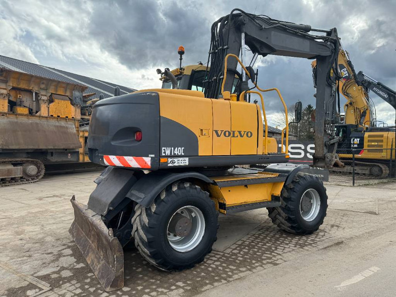 Volvo EW140C - DUTCH MACHINE - Bager na kotačima: slika Volvo EW140C - DUTCH MACHINE - Bager na kotačima Volvo EW140C - DUTCH MACHINE - Bager na kotačima: slika Volvo EW140C - DUTCH MACHINE - Bager na kotačima