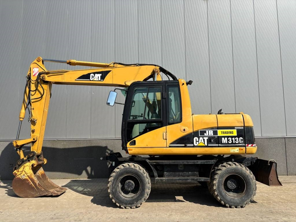 CAT M 313 C (Low verified hours) - Bager na kotačima: slika CAT M 313 C (Low verified hours) - Bager na kotačima CAT M 313 C (Low verified hours) - Bager na kotačima: slika CAT M 313 C (Low verified hours) - Bager na kotačima