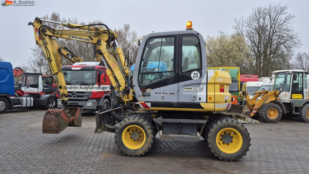 New Holland MH 2.6 Zustand gut, deutsche Maschine incl. Greifer und Dreservo - Bager na kotačima: slika New Holland MH 2.6 Zustand gut, deutsche Maschine incl. Greifer und Dreservo - Bager na kotačima New Holland MH 2.6 Zustand gut, deutsche Maschine incl. Greifer und Dreservo - Bager na kotačima: slika New Holland MH 2.6 Zustand gut, deutsche Maschine incl. Greifer und Dreservo - Bager na kotačima