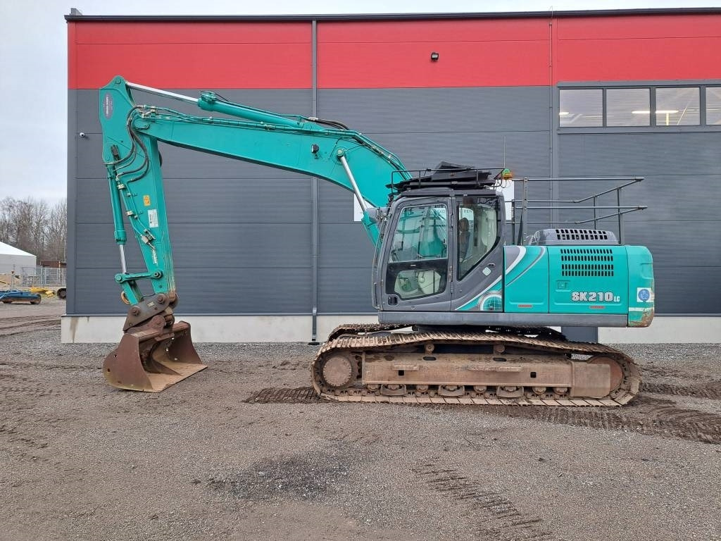 Kobelco SK 210 LC-10 - Bager gusjeničar: slika Kobelco SK 210 LC-10 - Bager gusjeničar Kobelco SK 210 LC-10 - Bager gusjeničar: slika Kobelco SK 210 LC-10 - Bager gusjeničar