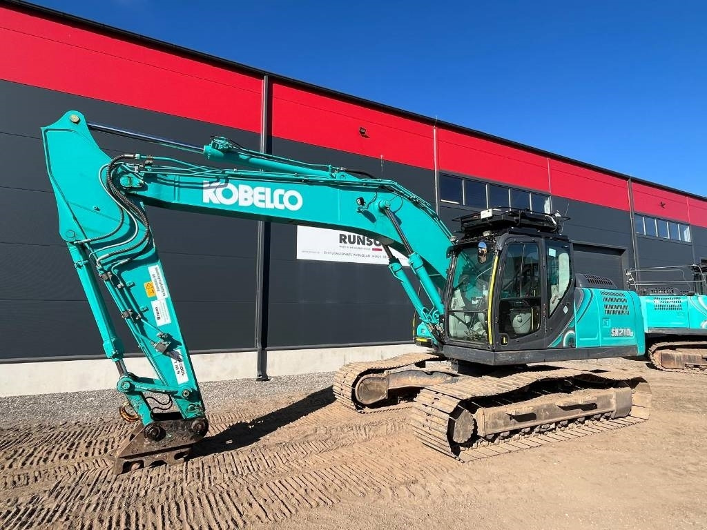 Kobelco SK 210 LC-10E - Bager gusjeničar: slika Kobelco SK 210 LC-10E - Bager gusjeničar Kobelco SK 210 LC-10E - Bager gusjeničar: slika Kobelco SK 210 LC-10E - Bager gusjeničar