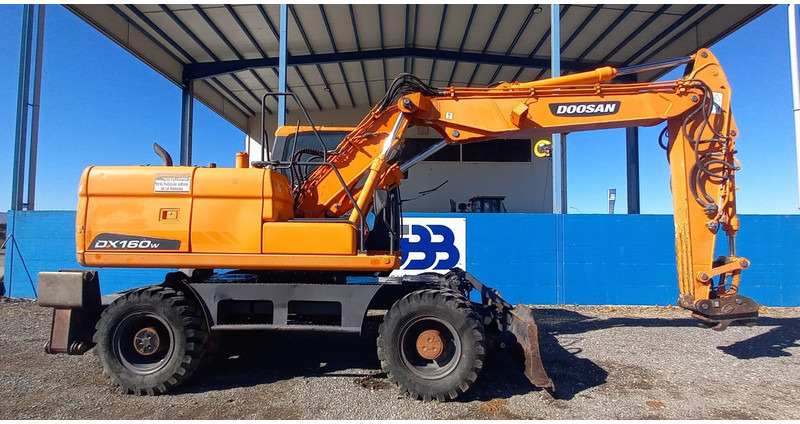 Doosan DX140W-3 - Bager na kotačima: slika Doosan DX140W-3 - Bager na kotačima Doosan DX140W-3 - Bager na kotačima: slika Doosan DX140W-3 - Bager na kotačima