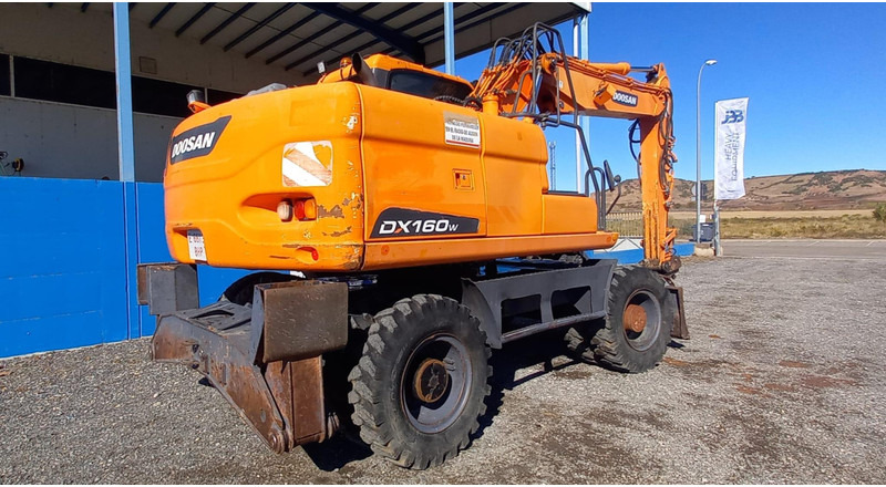 Doosan DX140W-3 - Bager na kotačima: slika Doosan DX140W-3 - Bager na kotačima Doosan DX140W-3 - Bager na kotačima: slika Doosan DX140W-3 - Bager na kotačima