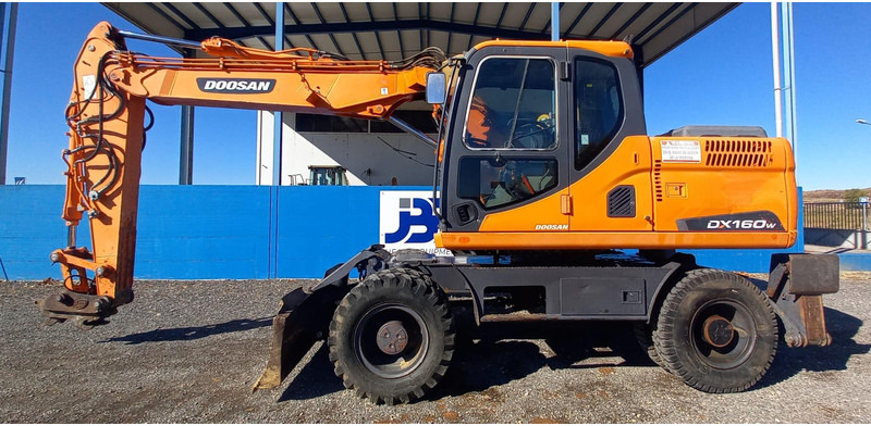Doosan DX140W-3 - Bager na kotačima: slika Doosan DX140W-3 - Bager na kotačima Doosan DX140W-3 - Bager na kotačima: slika Doosan DX140W-3 - Bager na kotačima