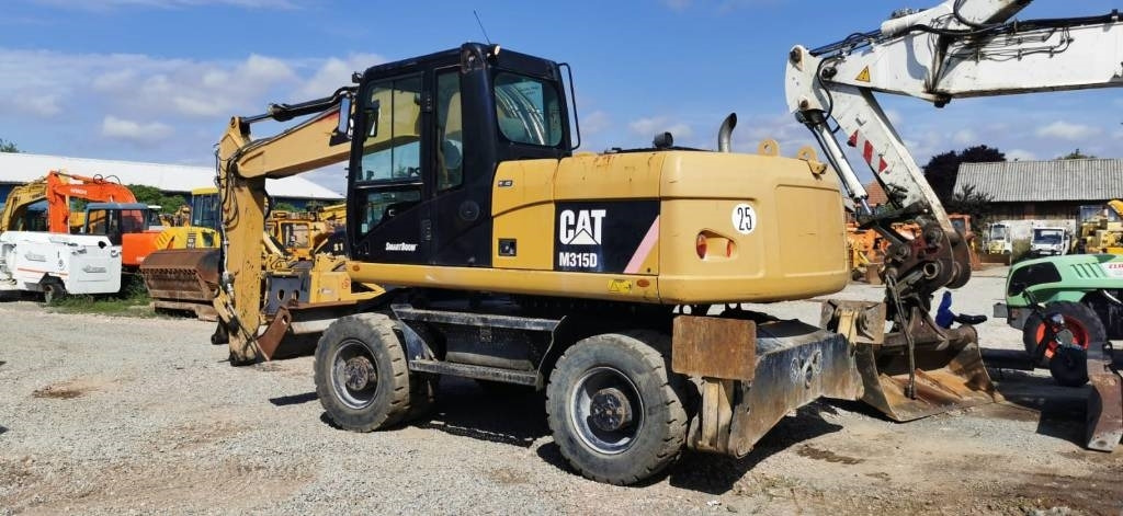 CAT M 315 D - Bager na kotačima: slika CAT M 315 D - Bager na kotačima CAT M 315 D - Bager na kotačima: slika CAT M 315 D - Bager na kotačima