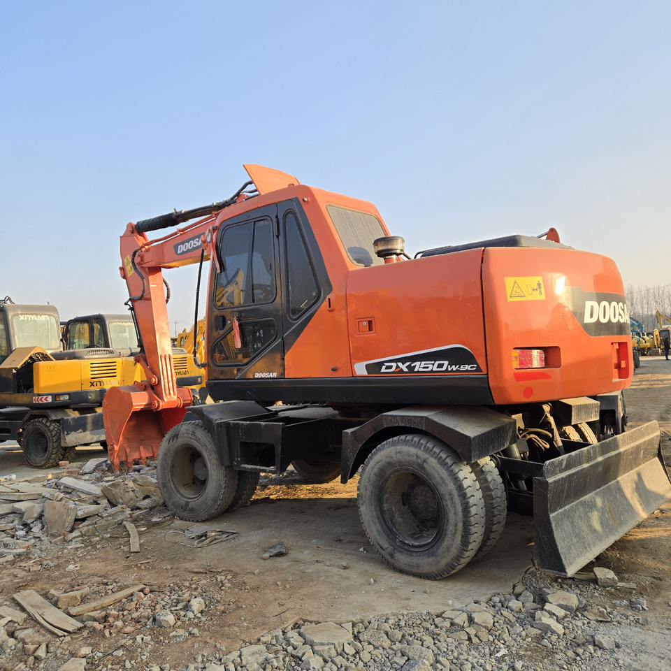 Doosan DX150W-9C - Bager na kotačima: slika Doosan DX150W-9C - Bager na kotačima Doosan DX150W-9C - Bager na kotačima: slika Doosan DX150W-9C - Bager na kotačima