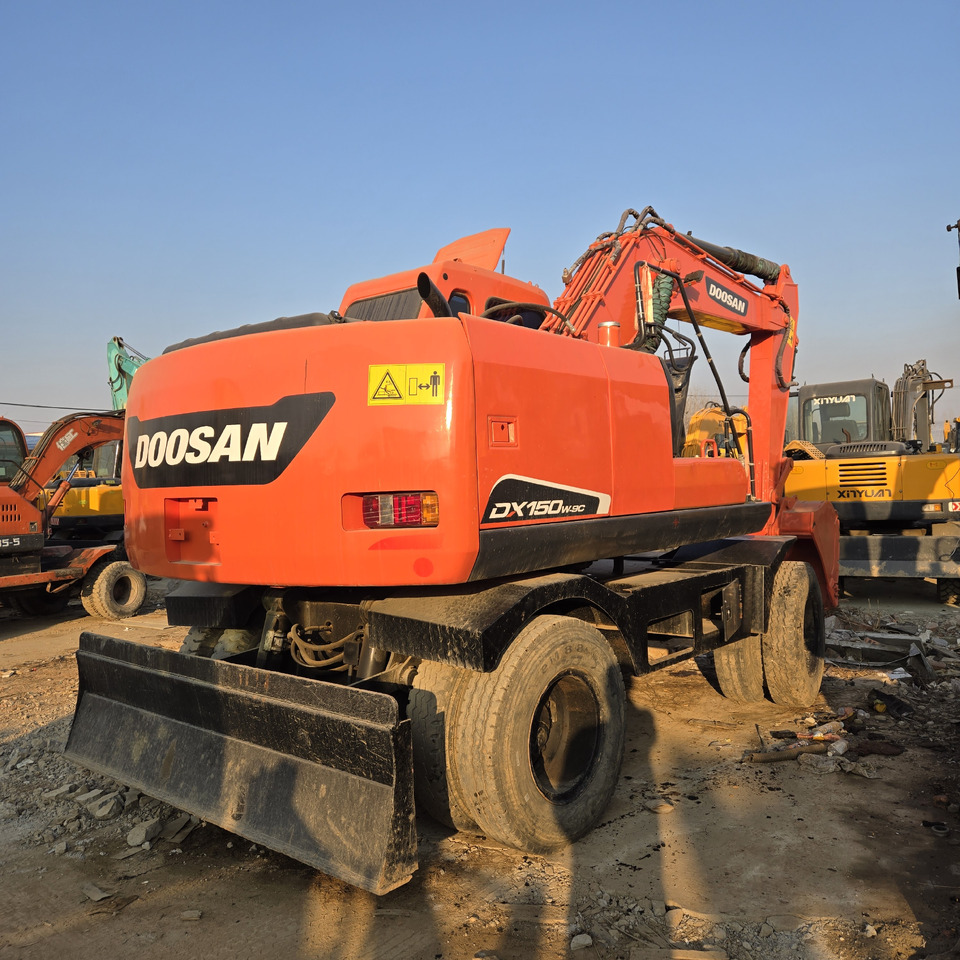 Doosan DX150W-9C - Bager na kotačima: slika Doosan DX150W-9C - Bager na kotačima Doosan DX150W-9C - Bager na kotačima: slika Doosan DX150W-9C - Bager na kotačima