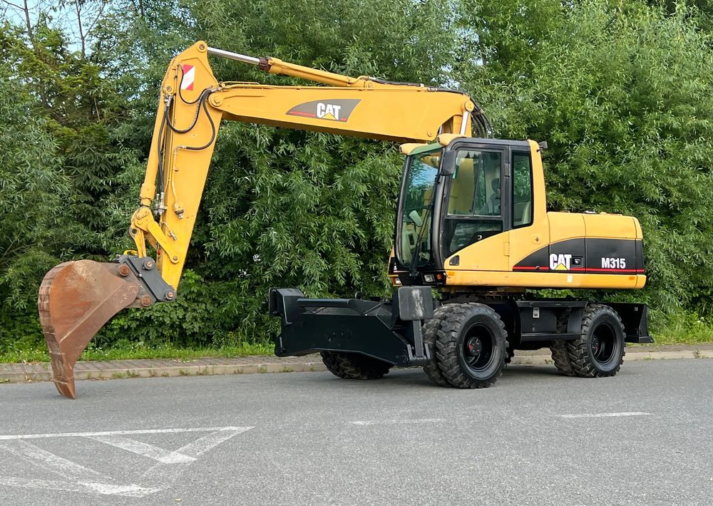 Caterpillar CAT M315C CATERPILLAR SPROWADZONY Bardzo Dobry Stan - Bager na kotačima: slika Caterpillar CAT M315C CATERPILLAR SPROWADZONY Bardzo Dobry Stan - Bager na kotačima Caterpillar CAT M315C CATERPILLAR SPROWADZONY Bardzo Dobry Stan - Bager na kotačima: slika Caterpillar CAT M315C CATERPILLAR SPROWADZONY Bardzo Dobry Stan - Bager na kotačima
