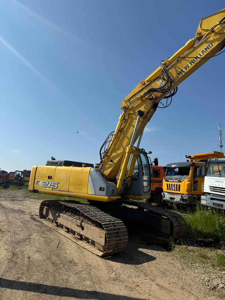 NEW HOLLAND E 215 EXCAVATOR - Bager gusjeničar: slika NEW HOLLAND E 215 EXCAVATOR - Bager gusjeničar NEW HOLLAND E 215 EXCAVATOR - Bager gusjeničar: slika NEW HOLLAND E 215 EXCAVATOR - Bager gusjeničar