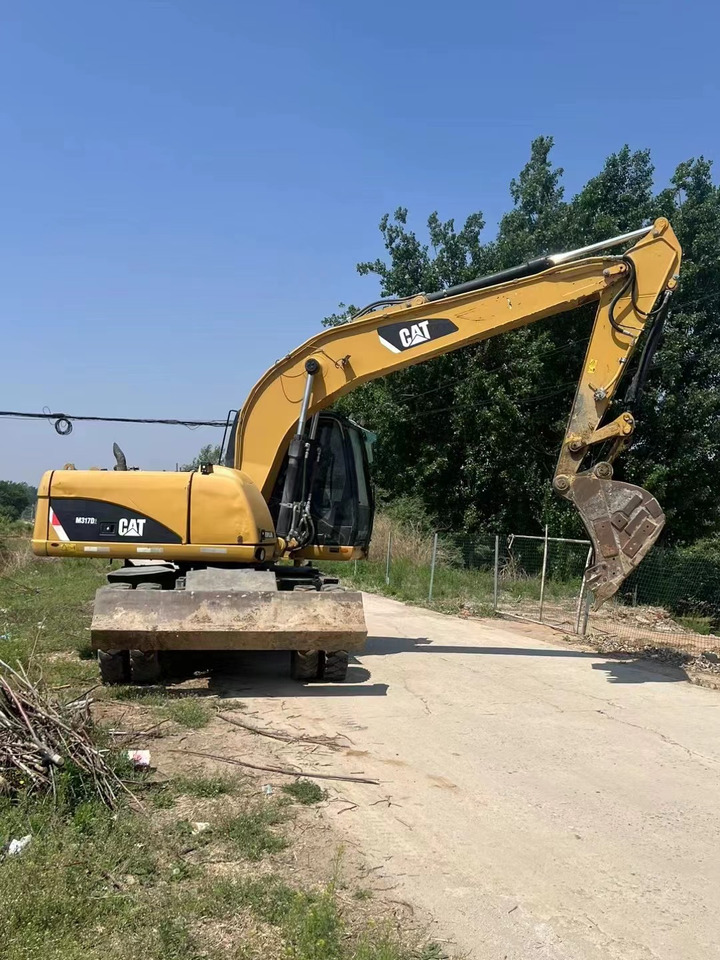CATERPILLAR M317 - Bager na kotačima: slika CATERPILLAR M317 - Bager na kotačima CATERPILLAR M317 - Bager na kotačima: slika CATERPILLAR M317 - Bager na kotačima