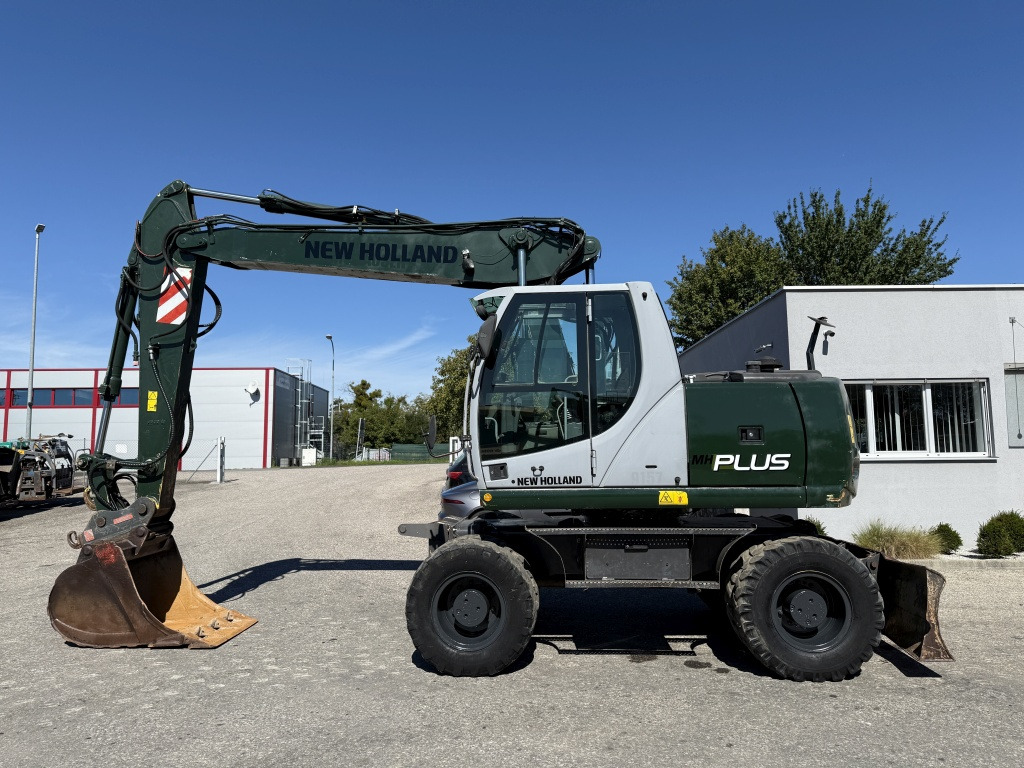 New Holland MH-Plus (111695) - Bager na kotačima: slika New Holland MH-Plus (111695) - Bager na kotačima New Holland MH-Plus (111695) - Bager na kotačima: slika New Holland MH-Plus (111695) - Bager na kotačima