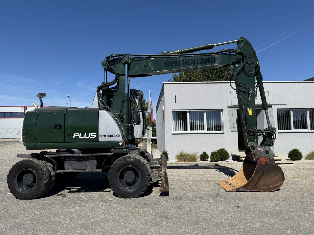 New Holland MH-Plus (111695) - Bager na kotačima: slika New Holland MH-Plus (111695) - Bager na kotačima New Holland MH-Plus (111695) - Bager na kotačima: slika New Holland MH-Plus (111695) - Bager na kotačima