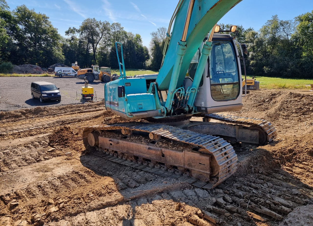 KOBELCO SK 210 NLC-6E - Bager gusjeničar: slika KOBELCO SK 210 NLC-6E - Bager gusjeničar KOBELCO SK 210 NLC-6E - Bager gusjeničar: slika KOBELCO SK 210 NLC-6E - Bager gusjeničar
