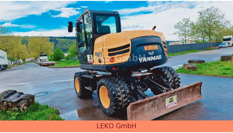 Yanmar B 95W Mit Drei Löffeln und Ein Hammer - Bager na kotačima: slika Yanmar B 95W Mit Drei Löffeln und Ein Hammer - Bager na kotačima Yanmar B 95W Mit Drei Löffeln und Ein Hammer - Bager na kotačima: slika Yanmar B 95W Mit Drei Löffeln und Ein Hammer - Bager na kotačima